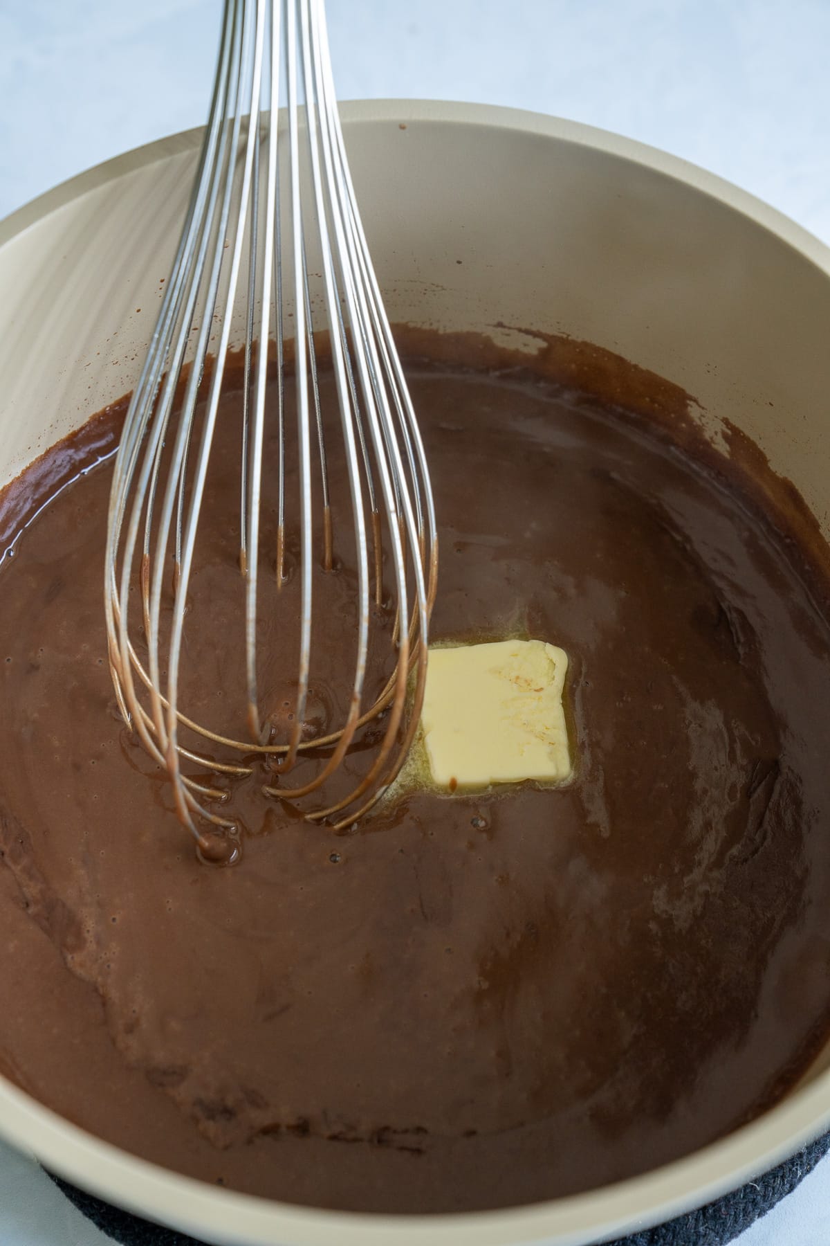 whisk stirring chocolate gravy after butter was added