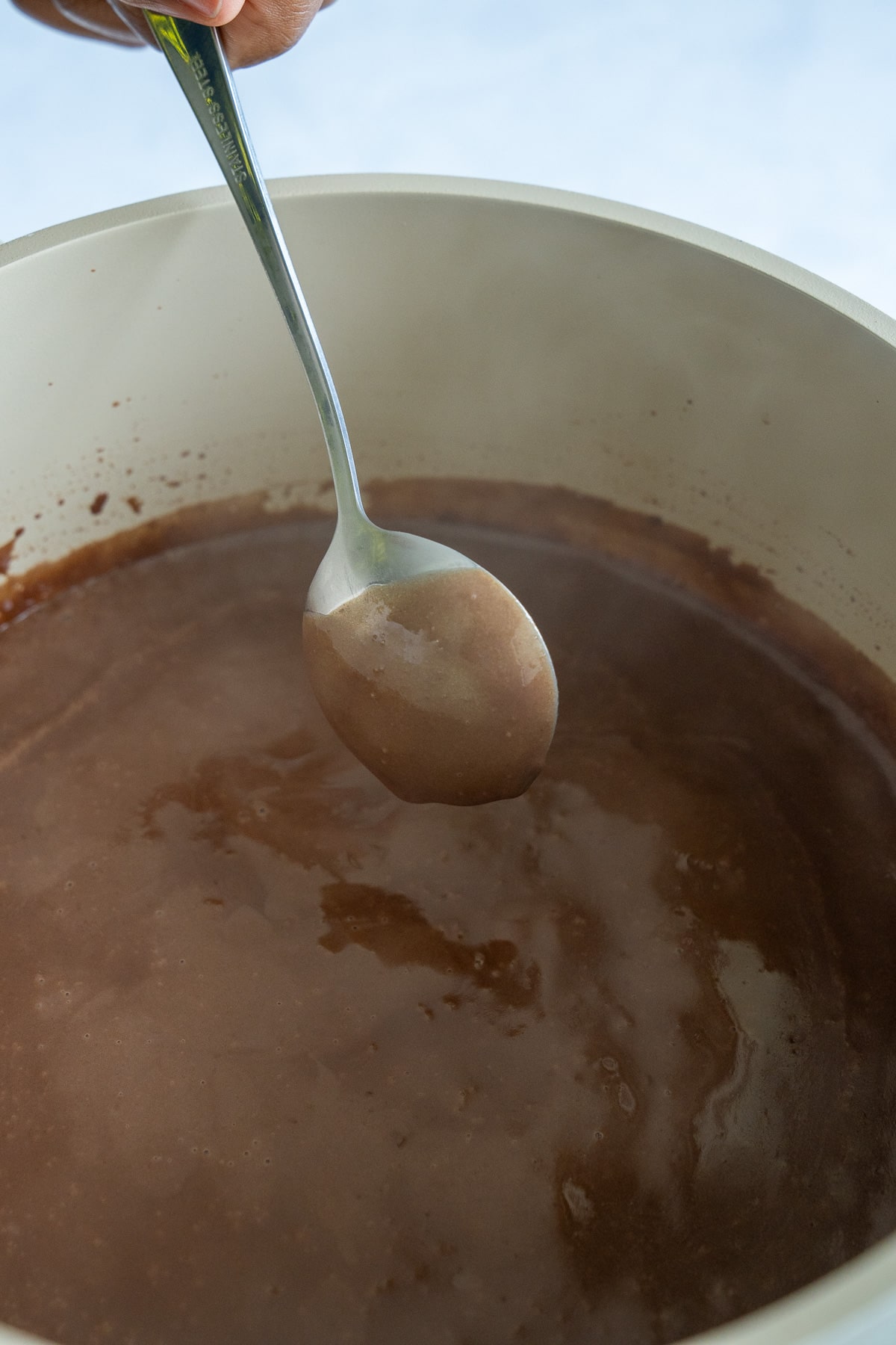 spoon showing thickness of chocolate gravy