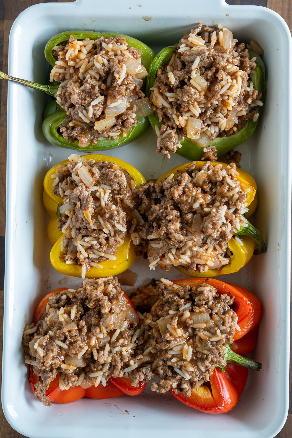 bell peppers in the baking dish before cheese and before baking with meat mixture inside