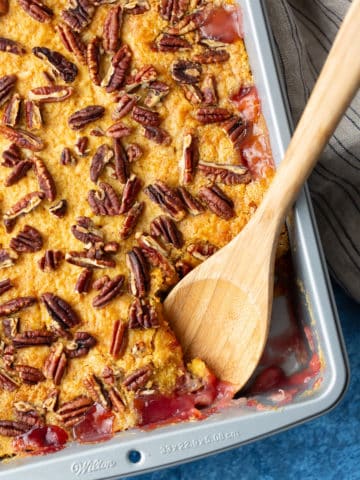 close up of dump cake with spoon taking some out