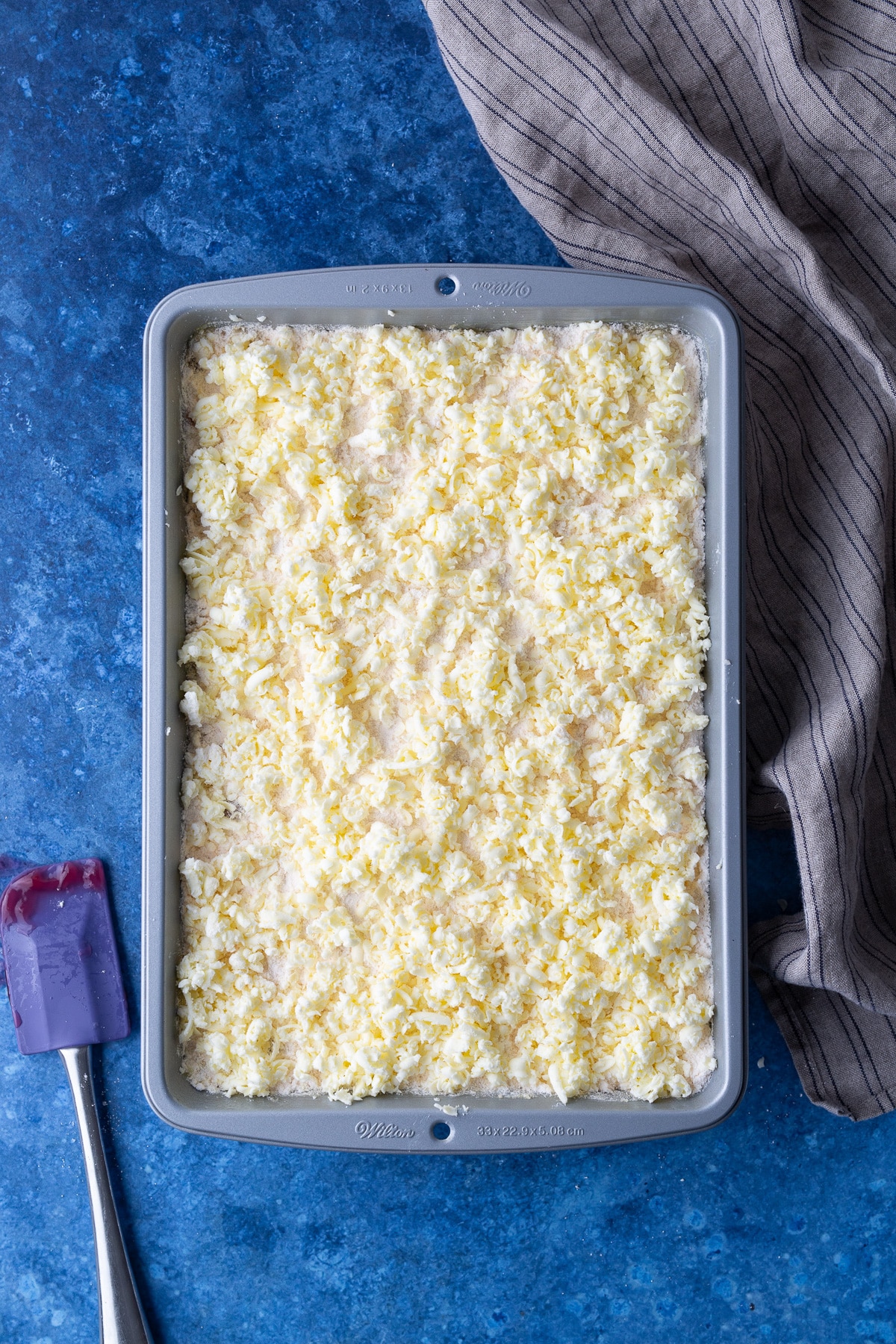 grated butter on top of cake in pan