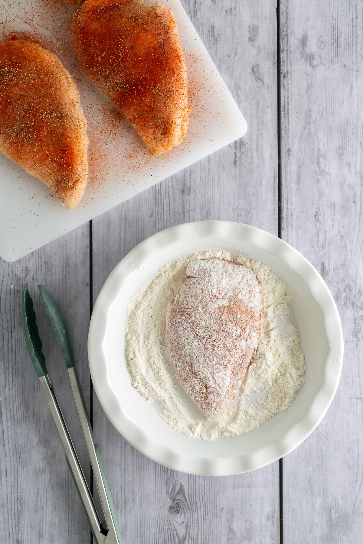 chicken coated in flour before searing in skillet