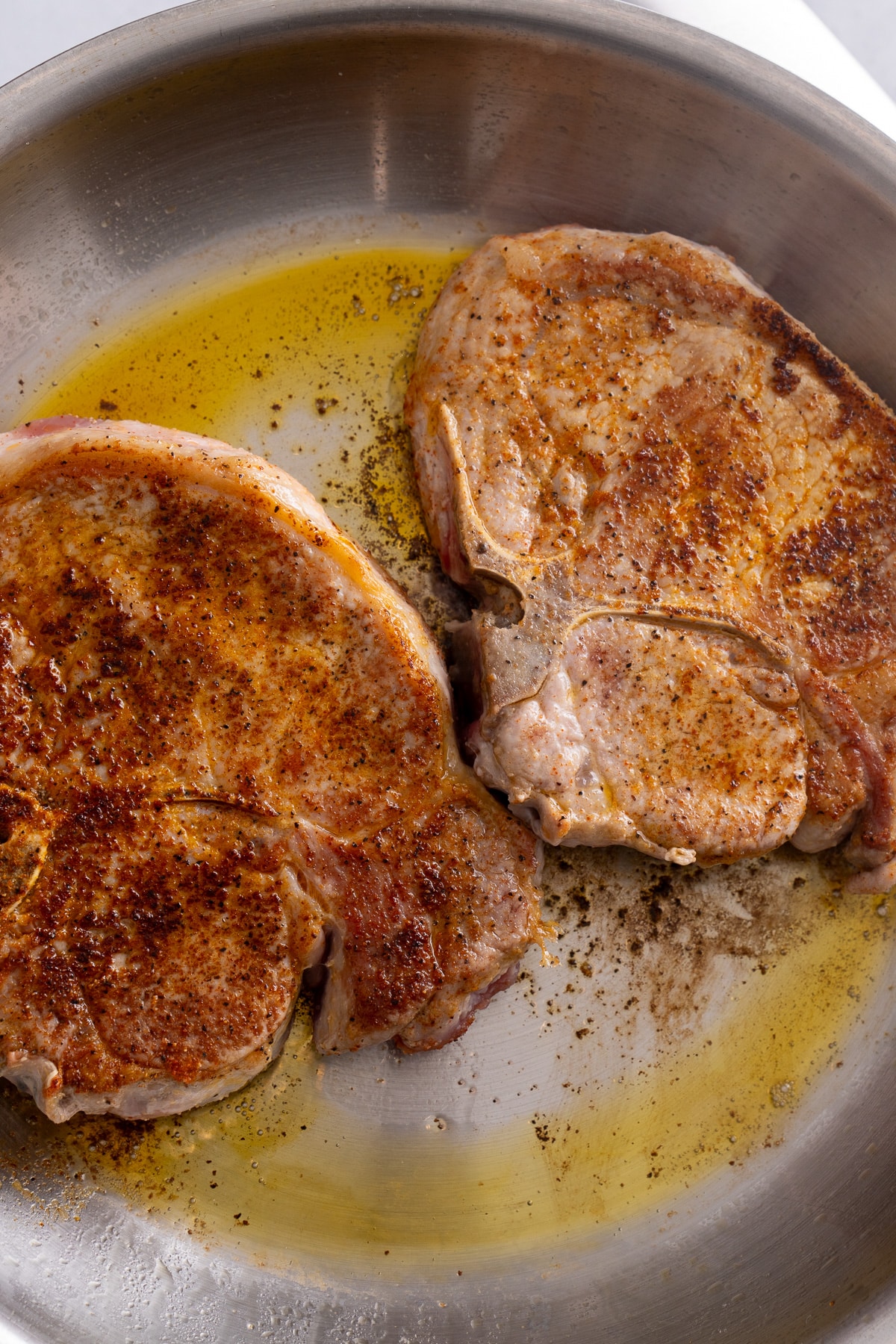 cooked pork chops in skillet