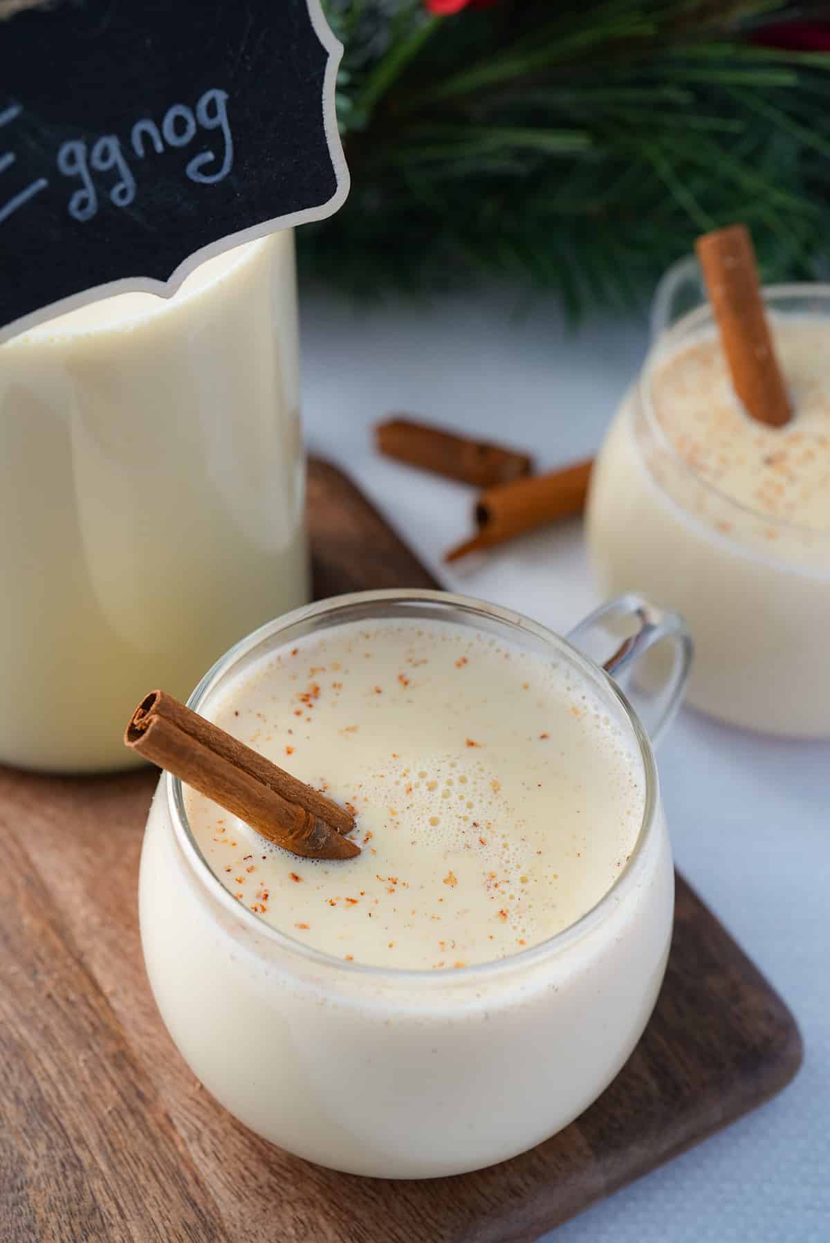 eggnog in glass with cinnamon stick sticking out