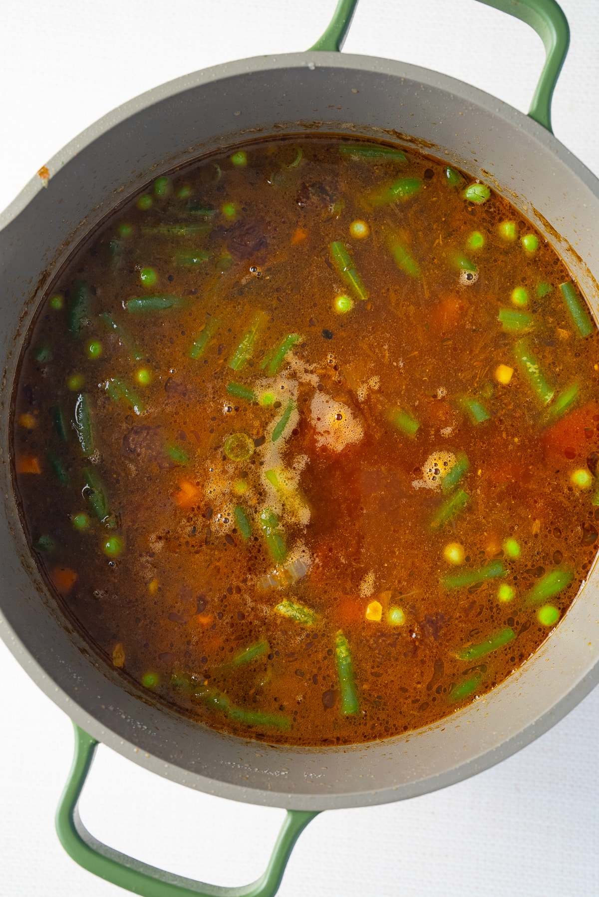 broth and vegetables and beef in pot