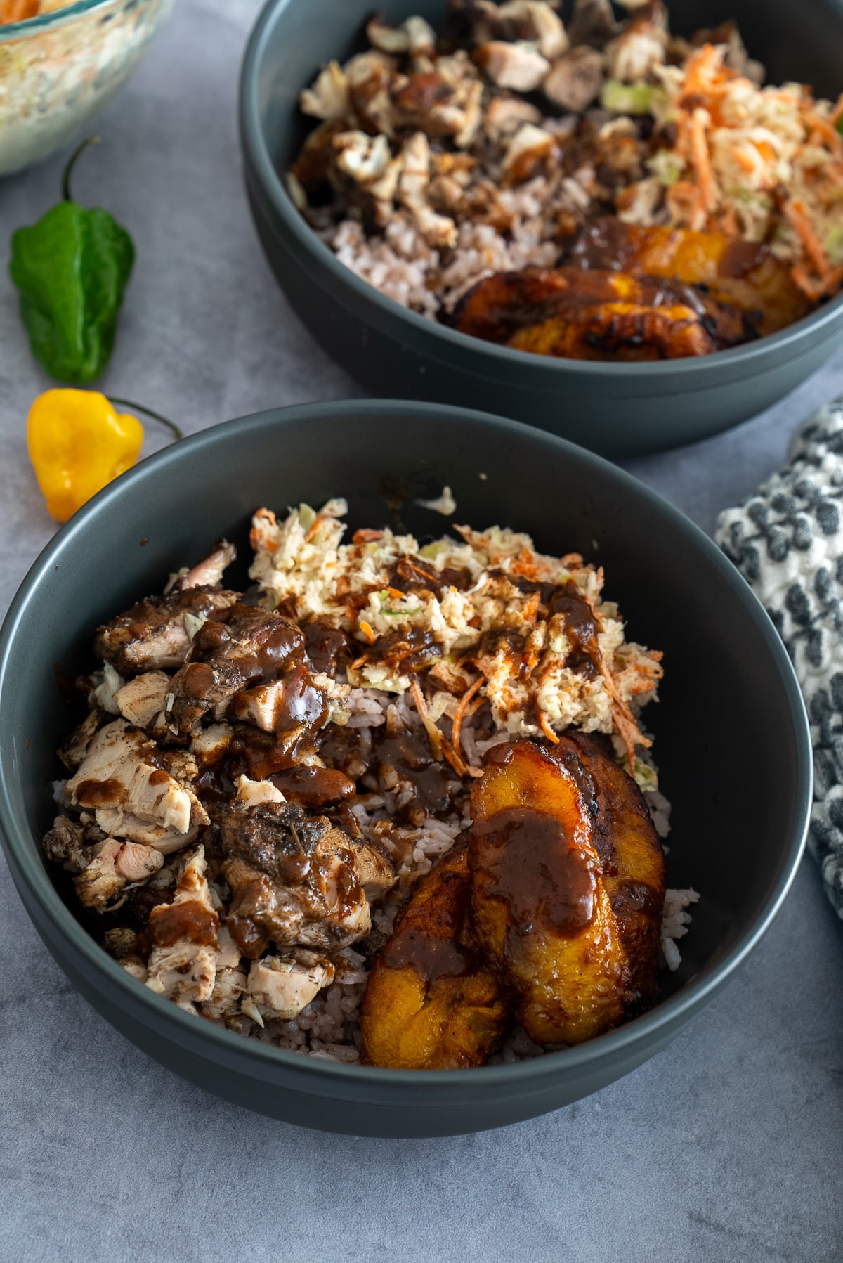 jerk chicken, rice, coleslaw, plantains in bowl to make a jerk chicken bowl