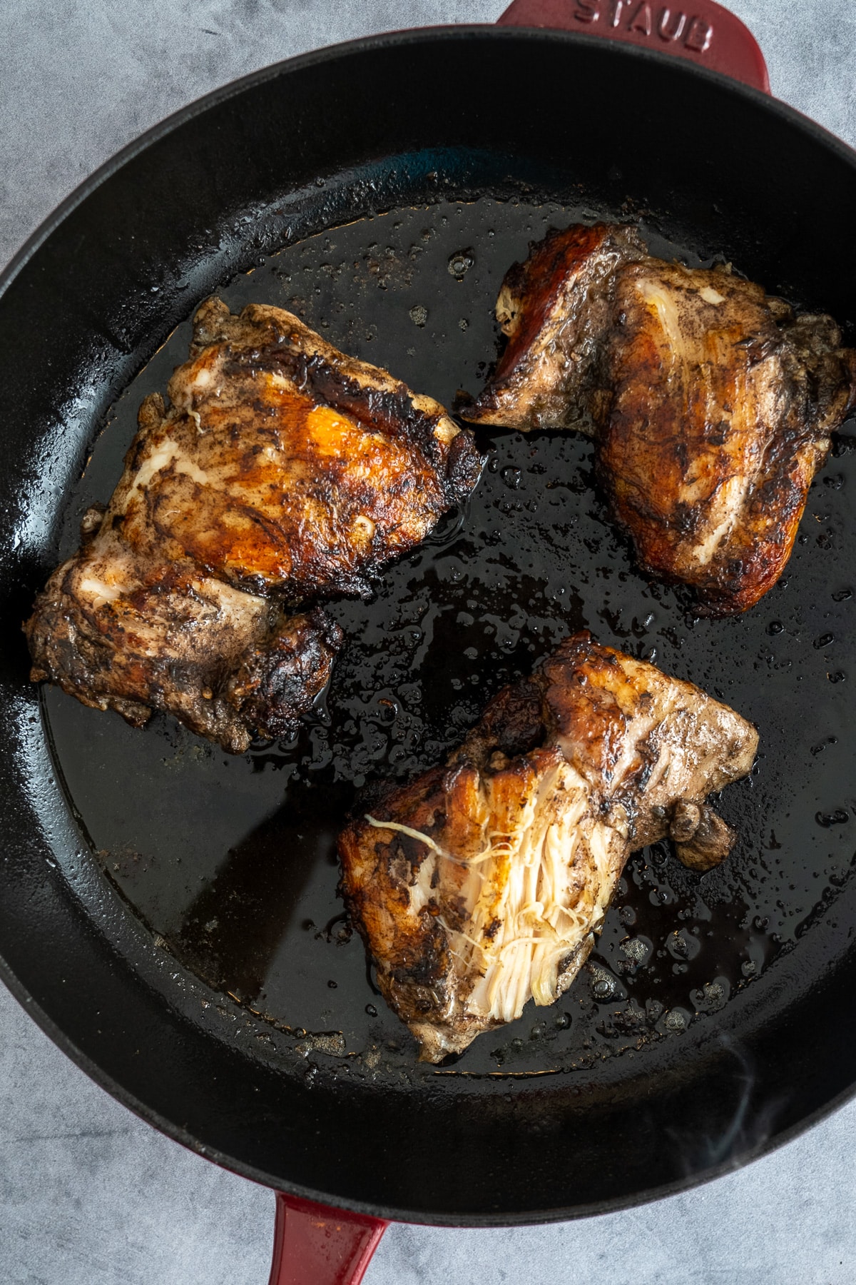 chicken thighs seared in skillet
