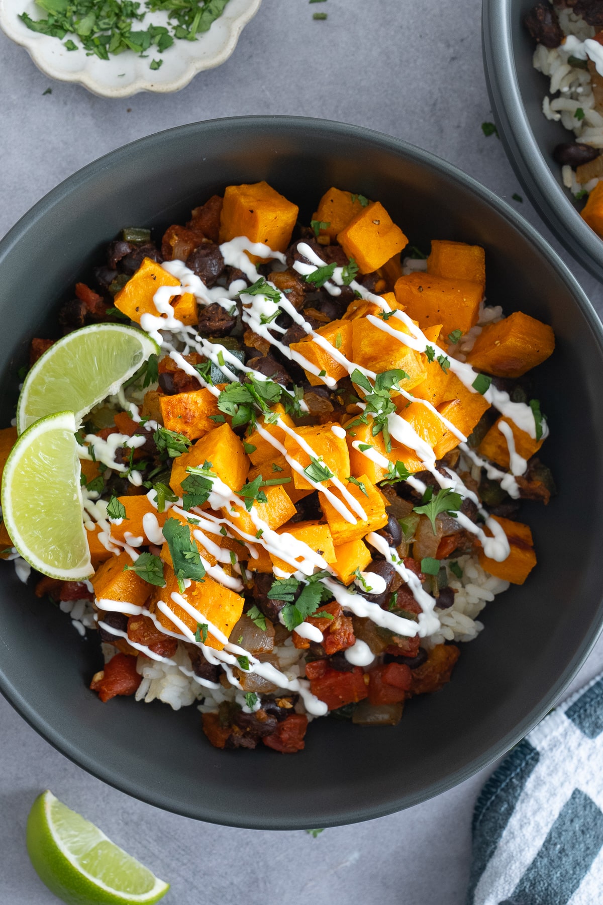 composed sweet potato bowl with sour cream drizzled on top