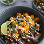 composed sweet potato bowl with sour cream drizzled on top