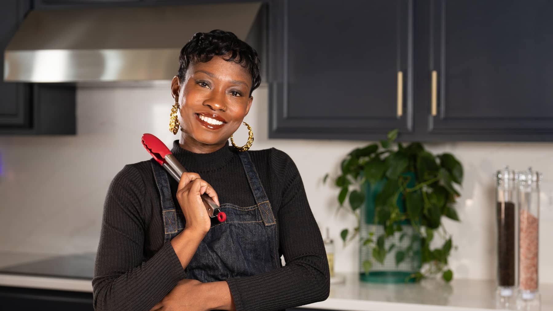 tanya holding tongs in the kitchen