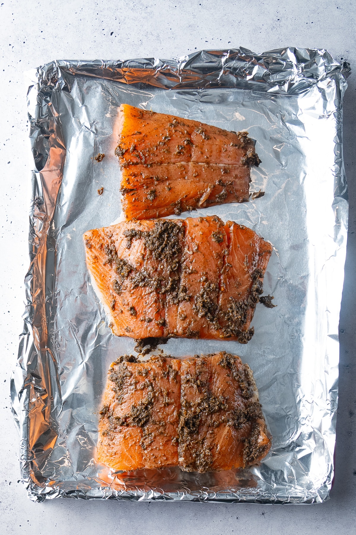 uncooked salmon filets covered in jerk seasoning