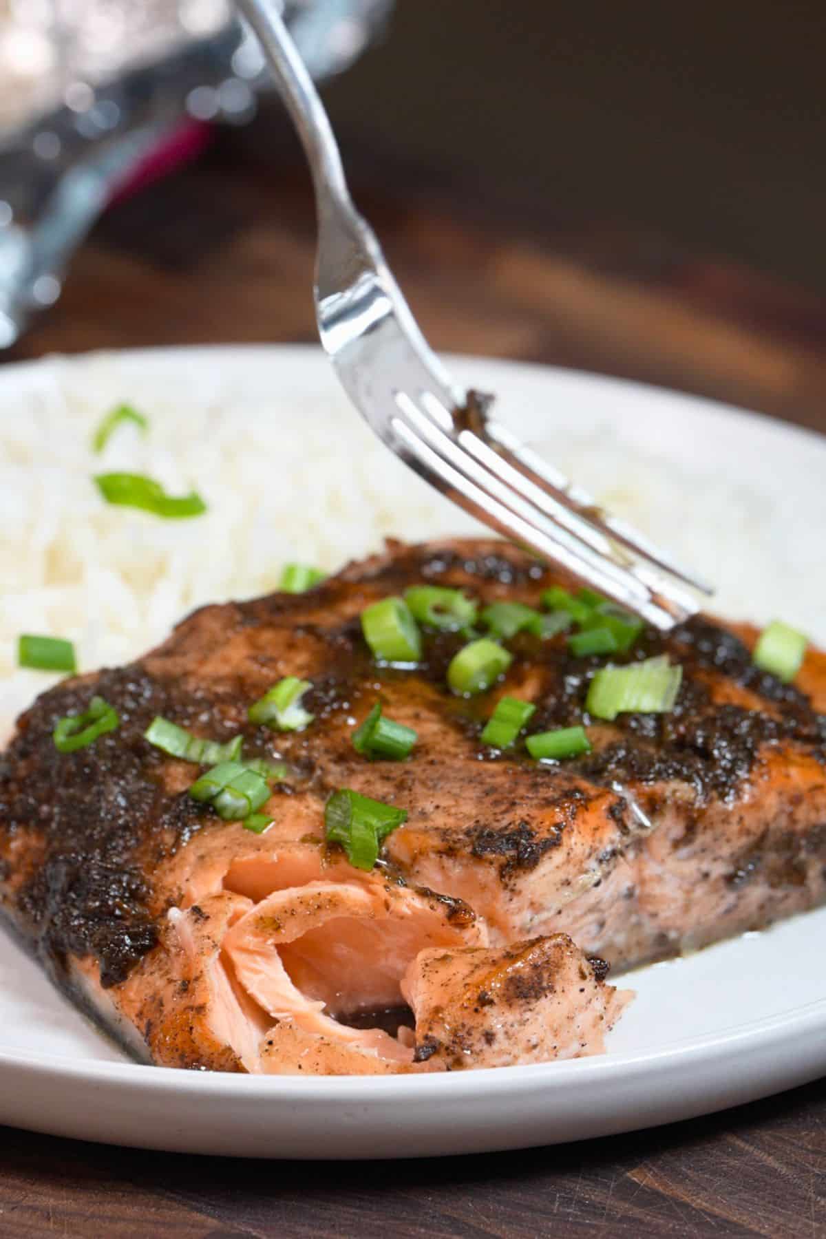 cooked jerk salmon flaked on a plate