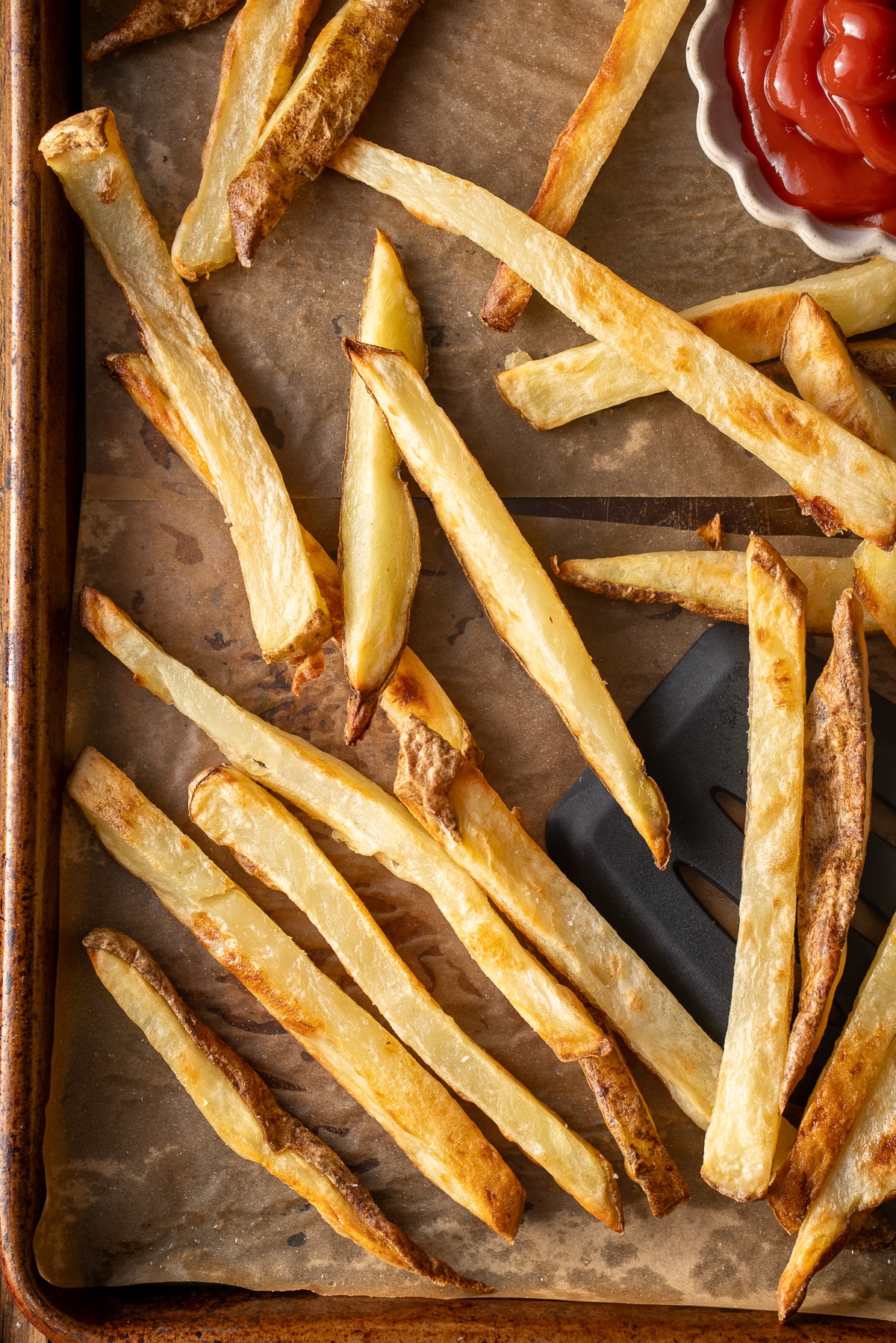 close up of baked fries on sheet pan