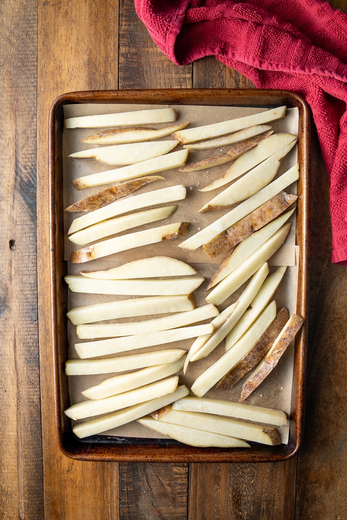 uncooked fries on baking sheet