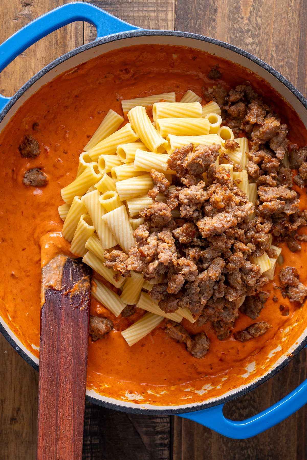 noodles and cooked Italian sausage on top of vodka sauce