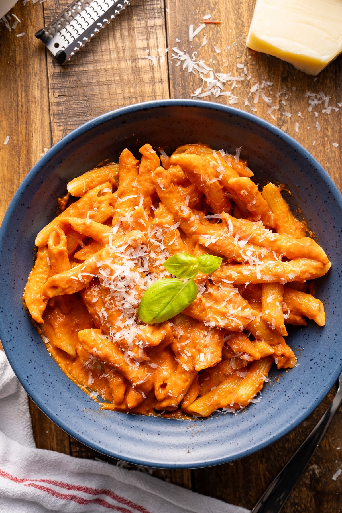 vodka sauce covering noodles with basil leaf on top