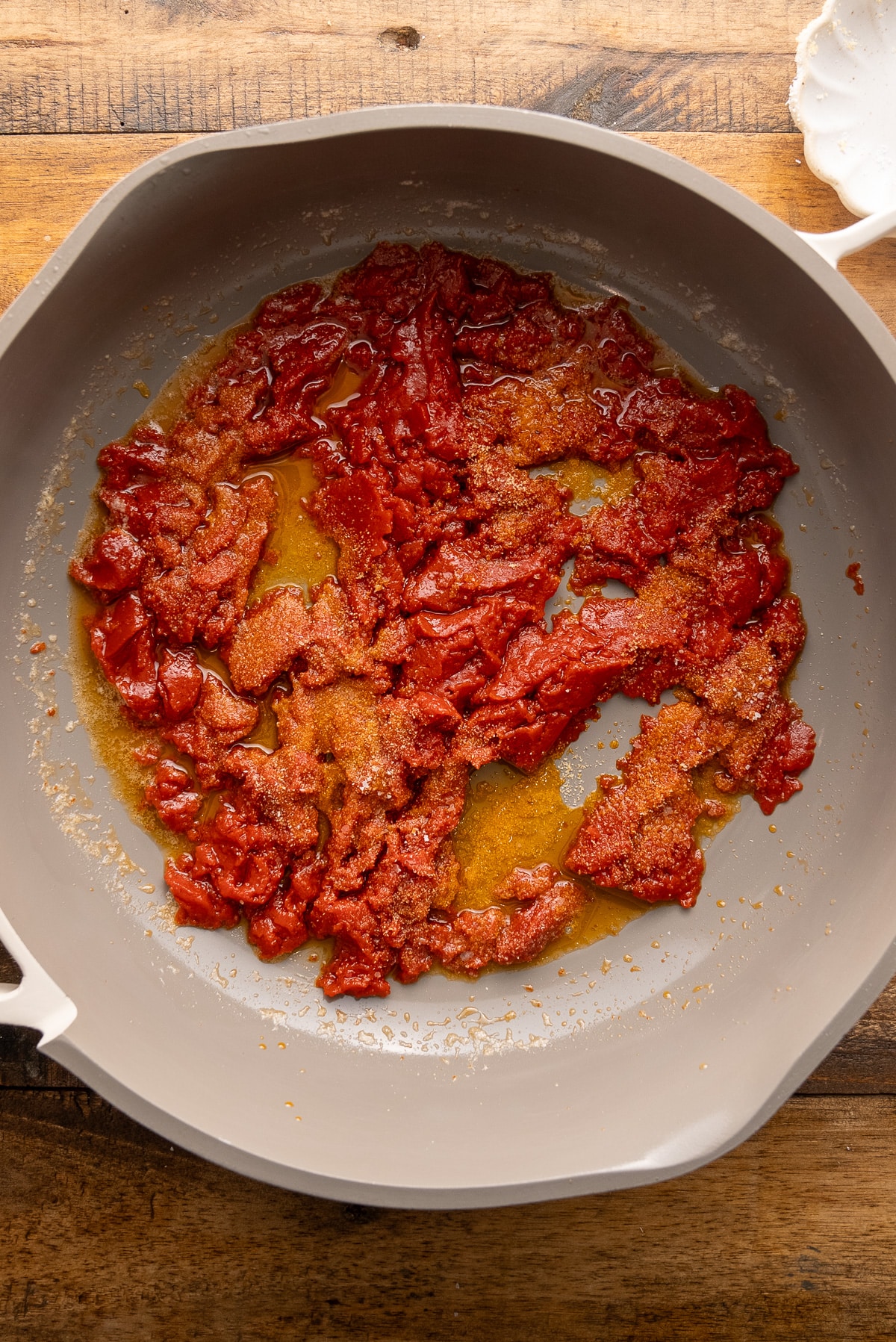 tomato paste and seasonings and butter in skillet