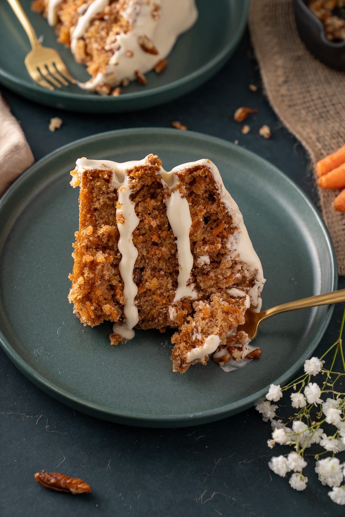 slice of carrot cake with fork breaking it apart