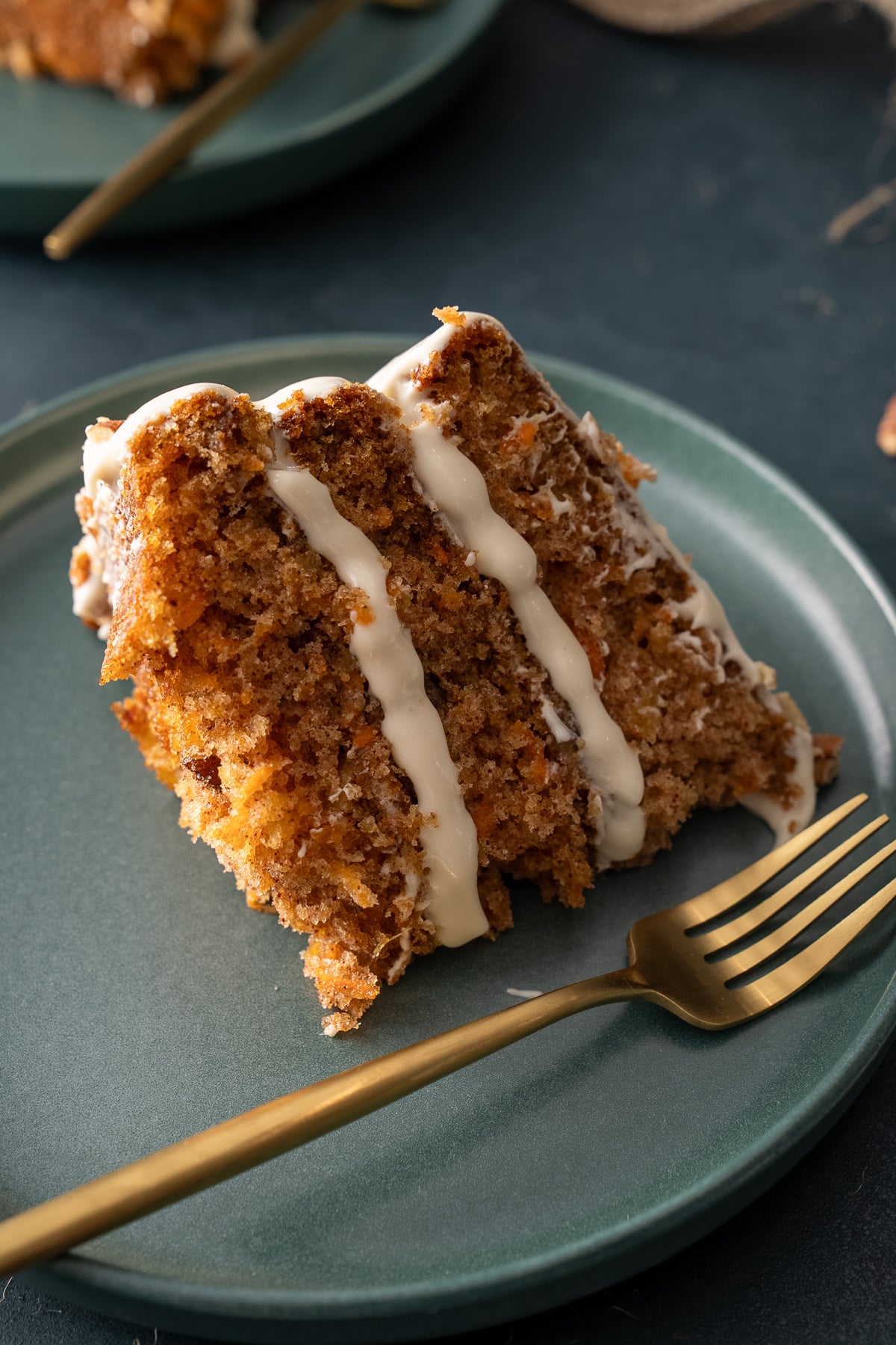 slie of carrot cake with fork on side