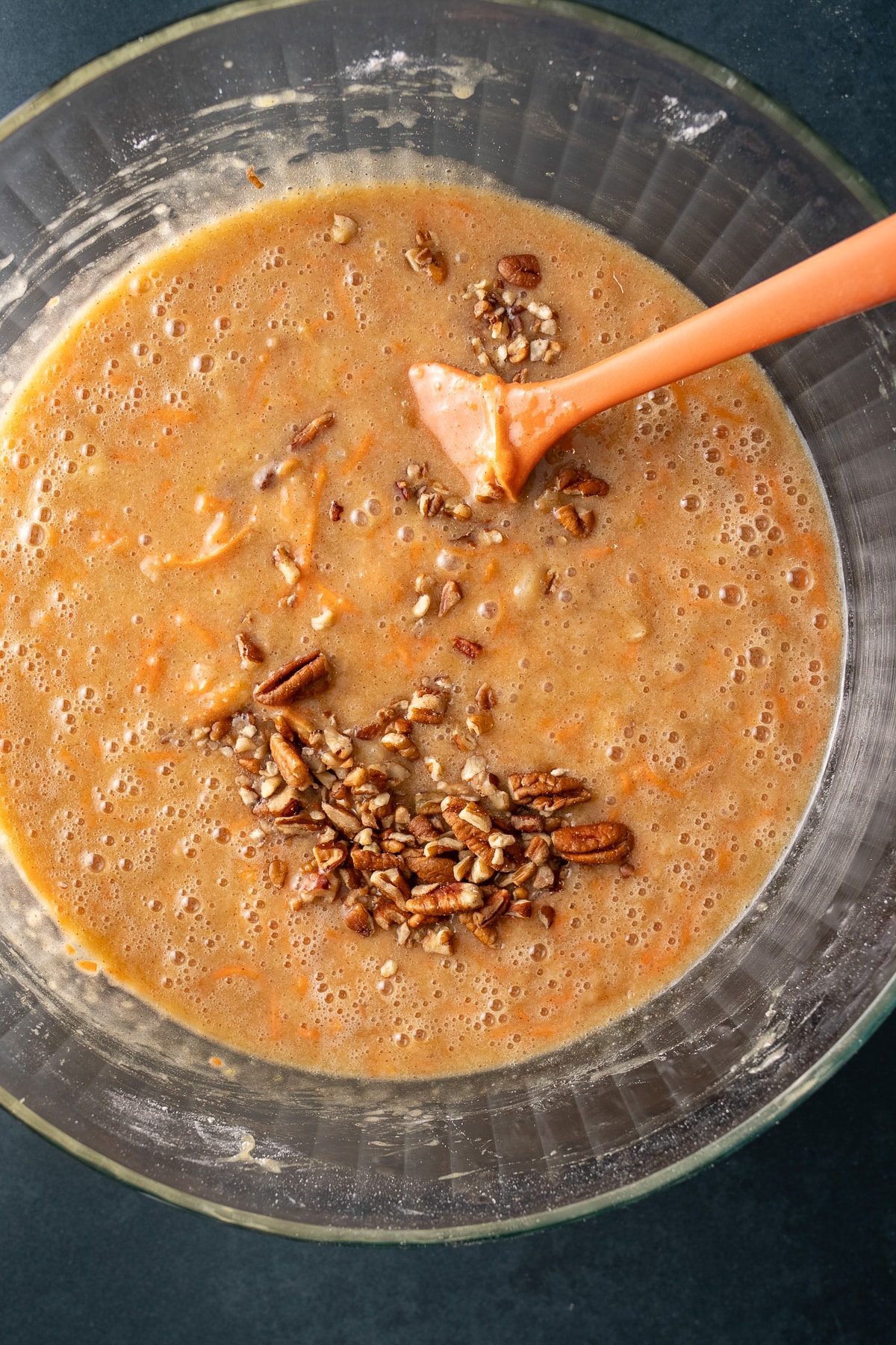 carrot cake batter in bwl with nuts on top