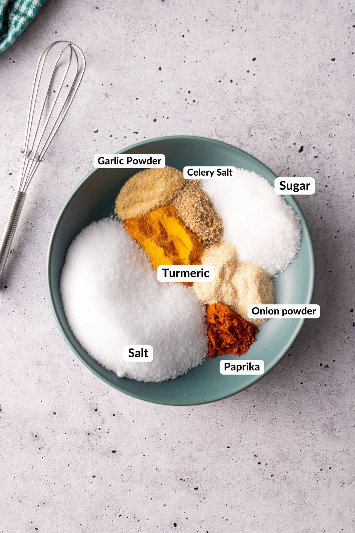 ingredients for seasoned salt in a bowl with labels