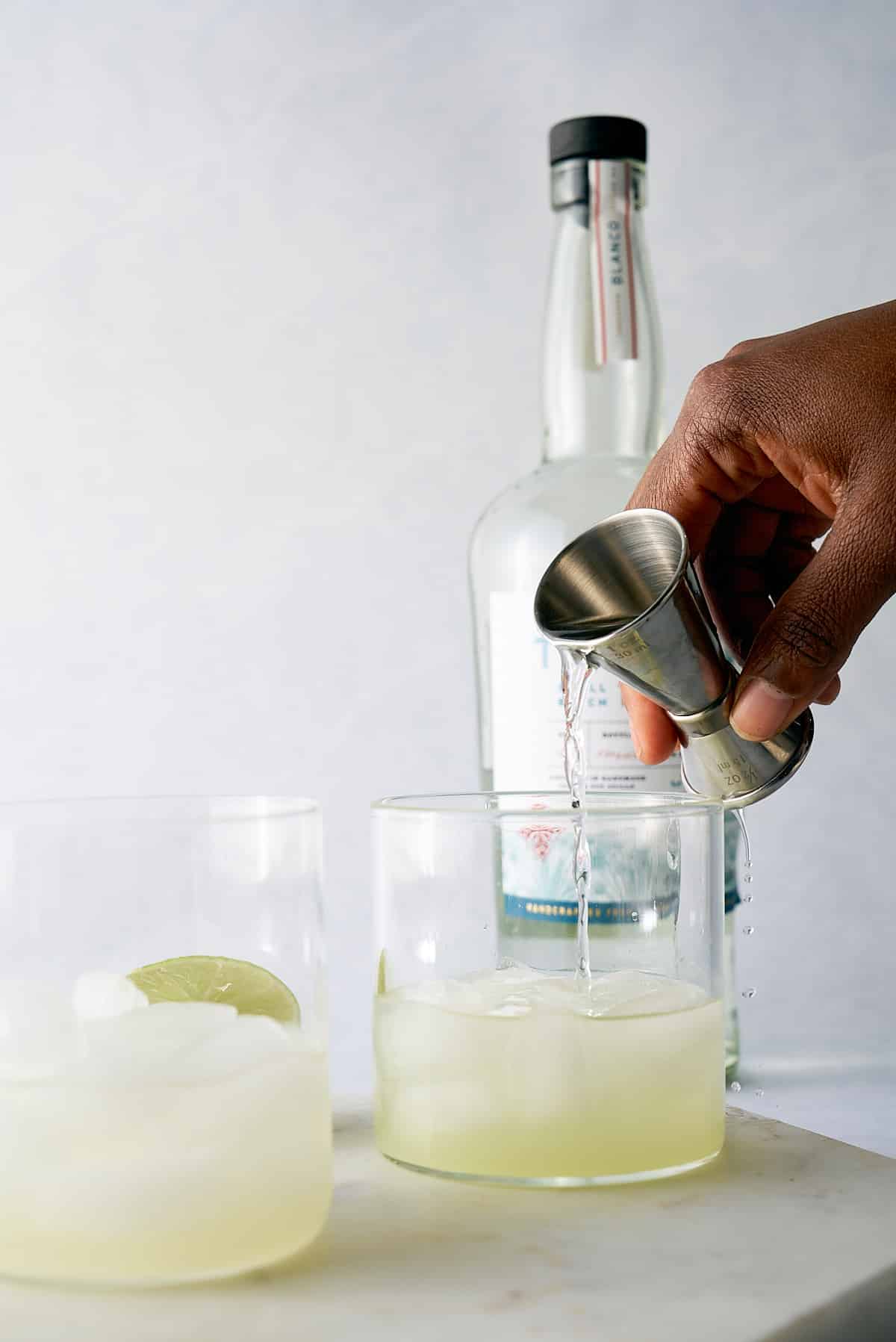 tequila being poured into glass