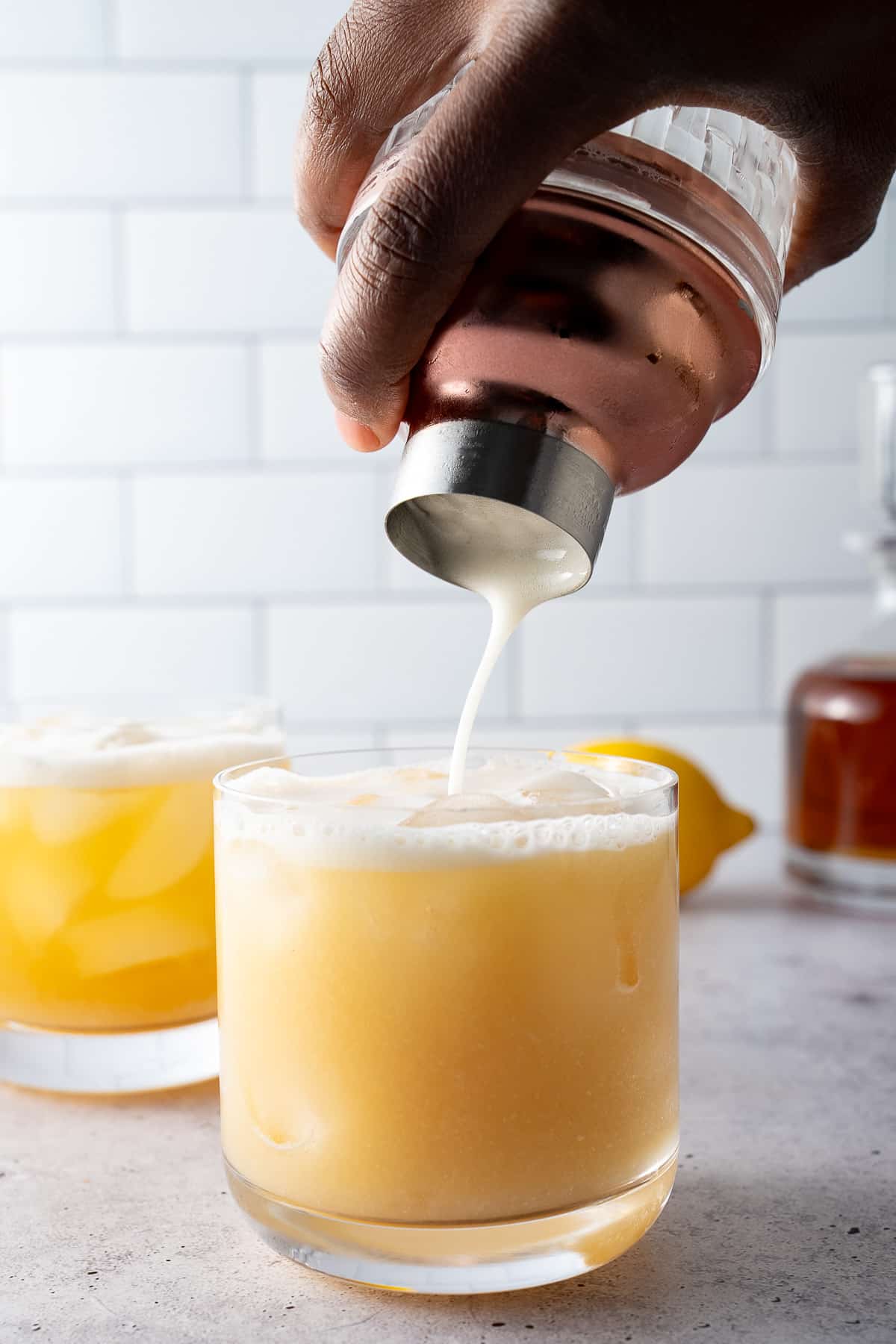 shiskey sour being poured into glass